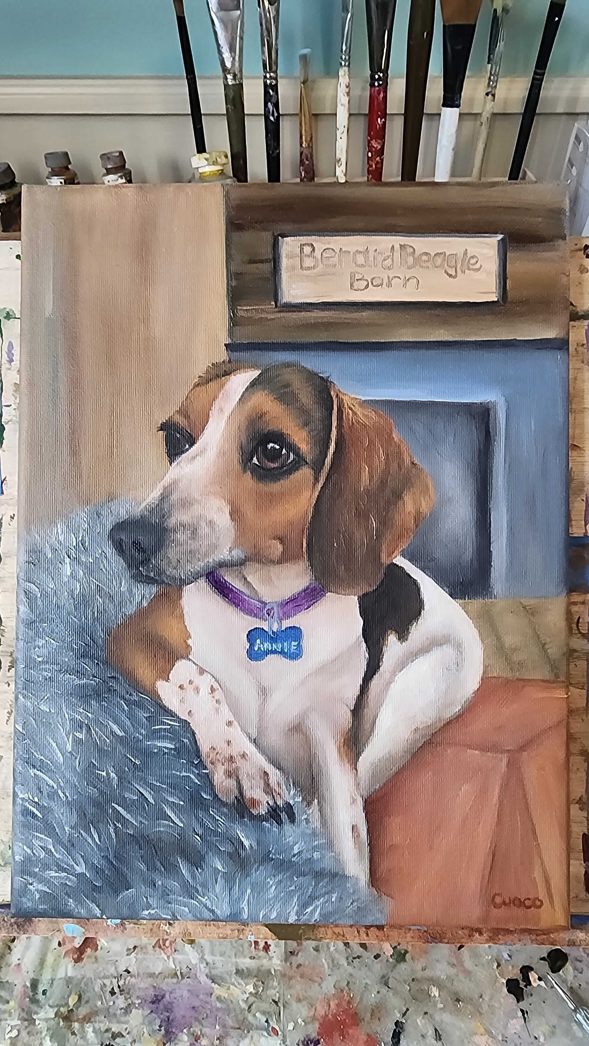 Realistic painting of a beagle named Annie on a blue plush blanket, featuring detailed fur textures.  Oil painting commission by artist, Nancy Cuoco.
