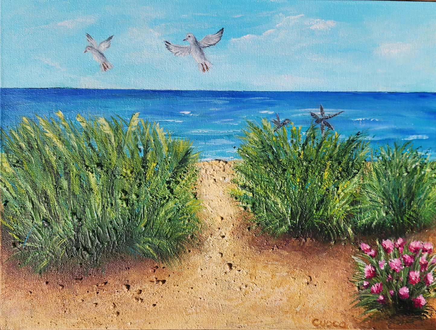 An acrylic painting of sand dunes and ocean with human ashes in the paint.  Two Seagulls, the large one the deceased husband watching over the wife.  Two dragonflies near by.